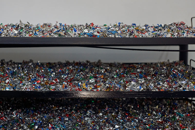 shredded aluminium in the wash station drying on racks