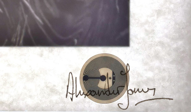 a high pass (x-ray type) scan through a print showing signature recto & NFC tag verso.
