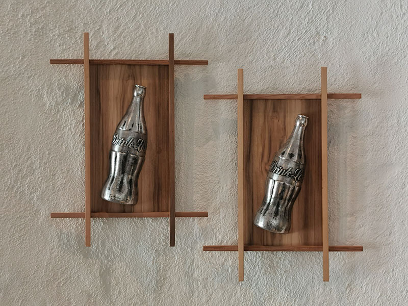 Drink Less aluminium sculptures based on the old glass style classic coke bottle